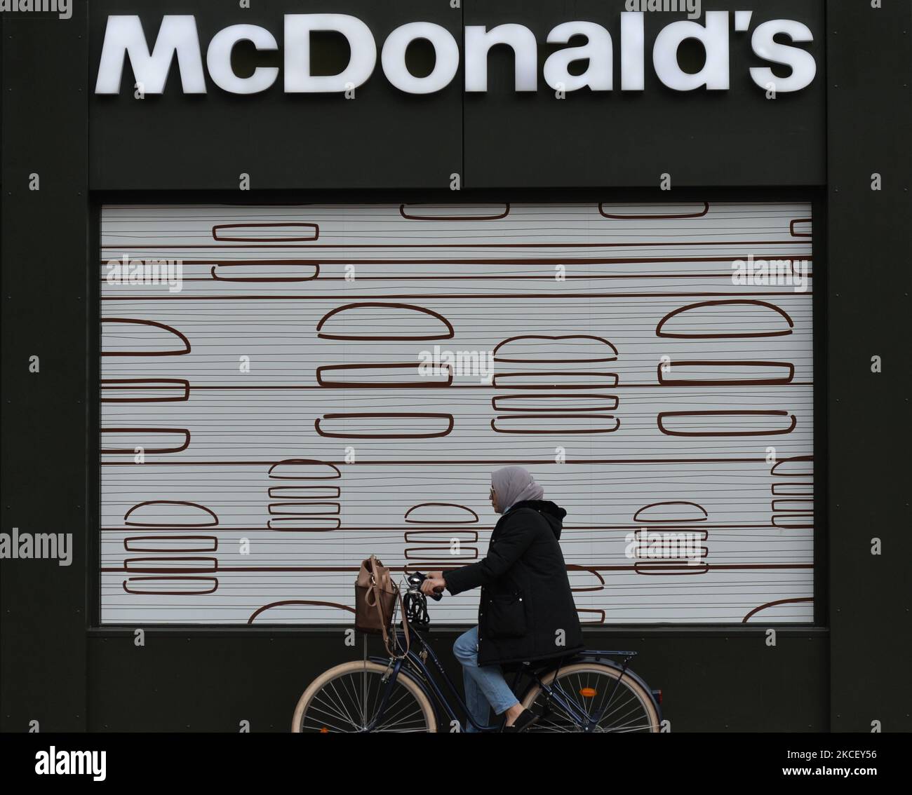 A cyclist drives past a McDonald's in Belfast city center. On Wednesday, May 19, 2021, in Belfast, Northern Ireland (Photo by Artur Widak/NurPhoto) Stock Photo