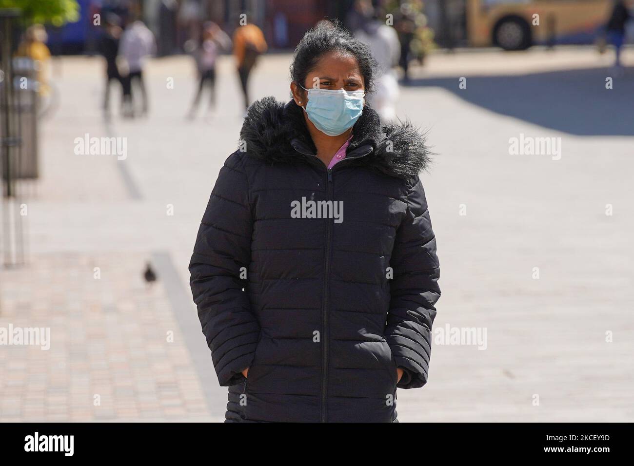 A woman wearing a face covering walks in Bolton town centre. Bolton has