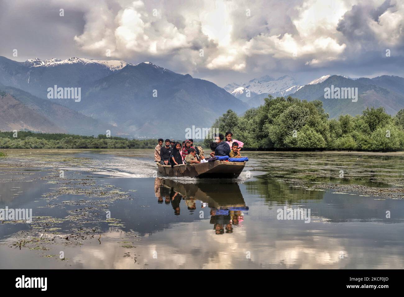 Kashmiris seen in a boat as they use water transport to move from one