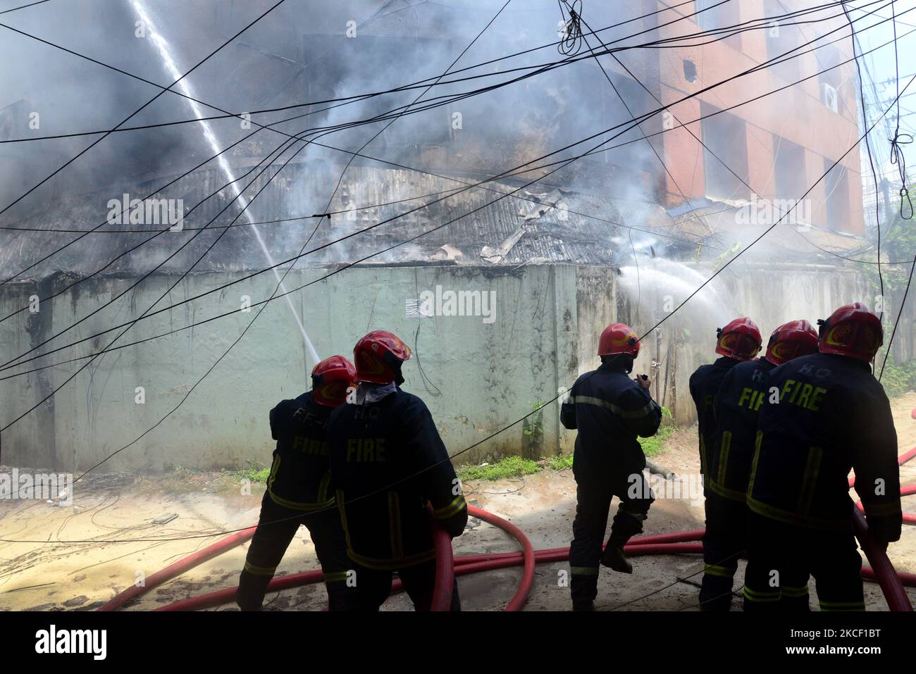 Firefighters try to extinguish a fire in a high-rise building at ...