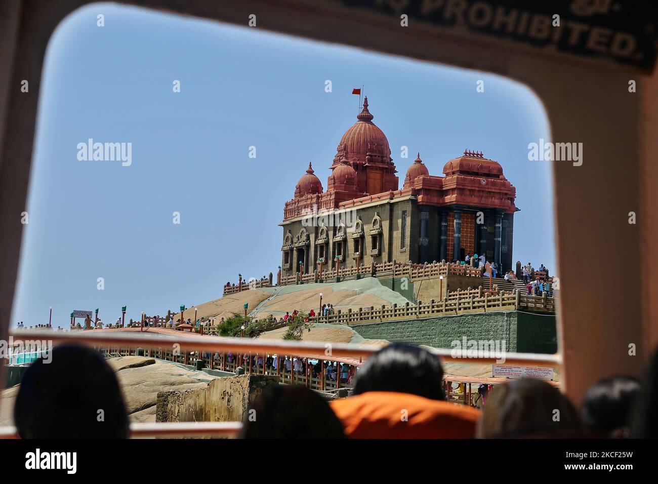 Passengers on a ferry boat look out towards the Vivekananda Rock Memorial Temple in Kanyakumari, Tamil Nadu, India. The Vivekananda Rock Memorial was built in 1970 in honour of Swami Vivekananda who is said to have attained enlightenment on the rock. (Photo by Creative Touch Imaging Ltd./NurPhoto) Stock Photo