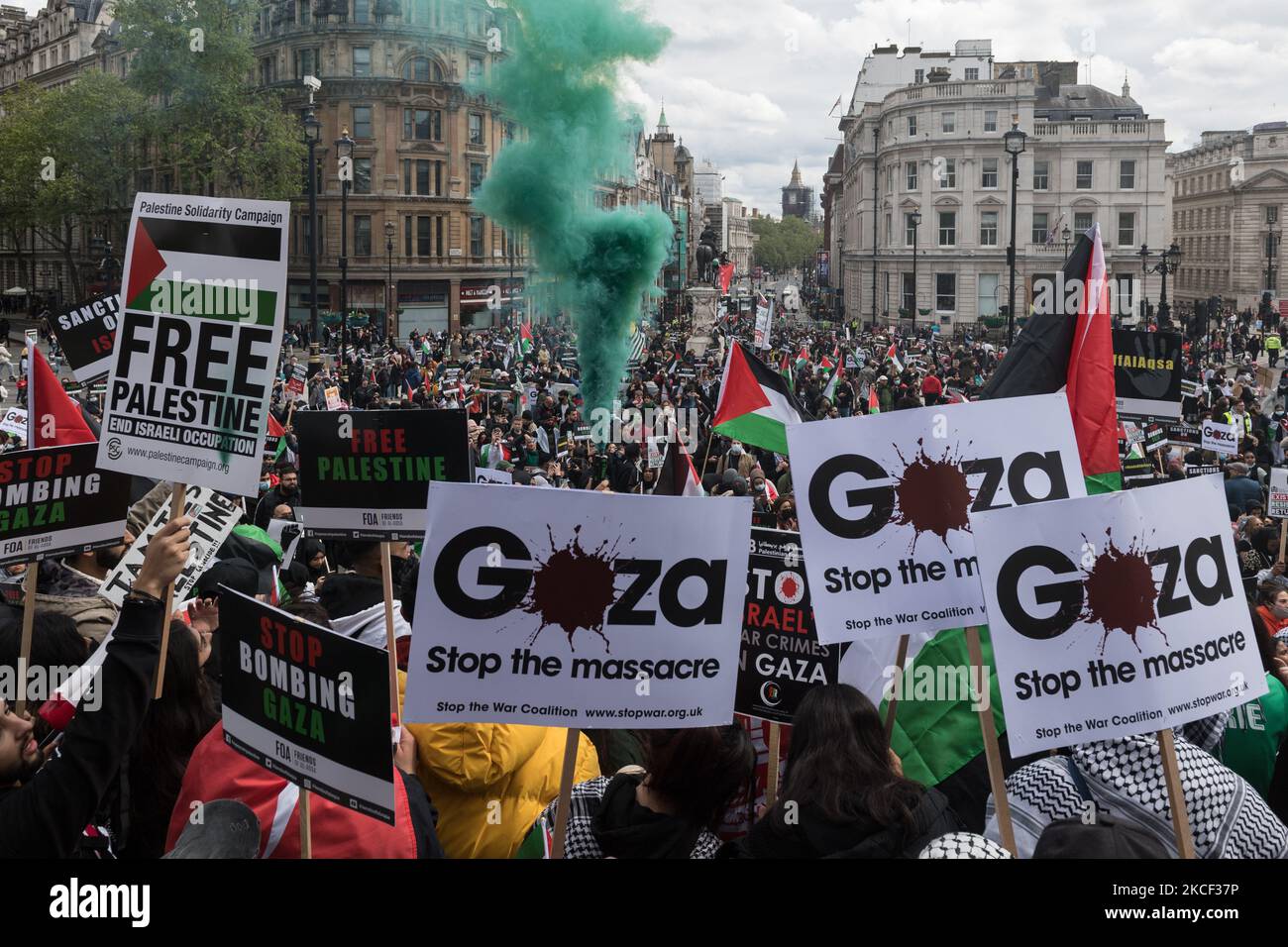 LONDON, UNITED KINGDOM - MAY 22, 2021: A smoke flare is set off as tens of thousands of protesters gather in Trafalgar Square in central London during a demonstration in support of Palestine, on 22 May, 2021 in London, England. A ceasefire between Israel and Palestine came into force on Friday following 11 days of air strikes that left more than 250 dead as conflict escalated over planned evictions of Palestinian families from their homes by Jewish settlers in the Sheikh Jarrah district of East Jerusalem and clashes with security forces around the Old City during Ramadan. (Photo by WIktor Szym Stock Photo