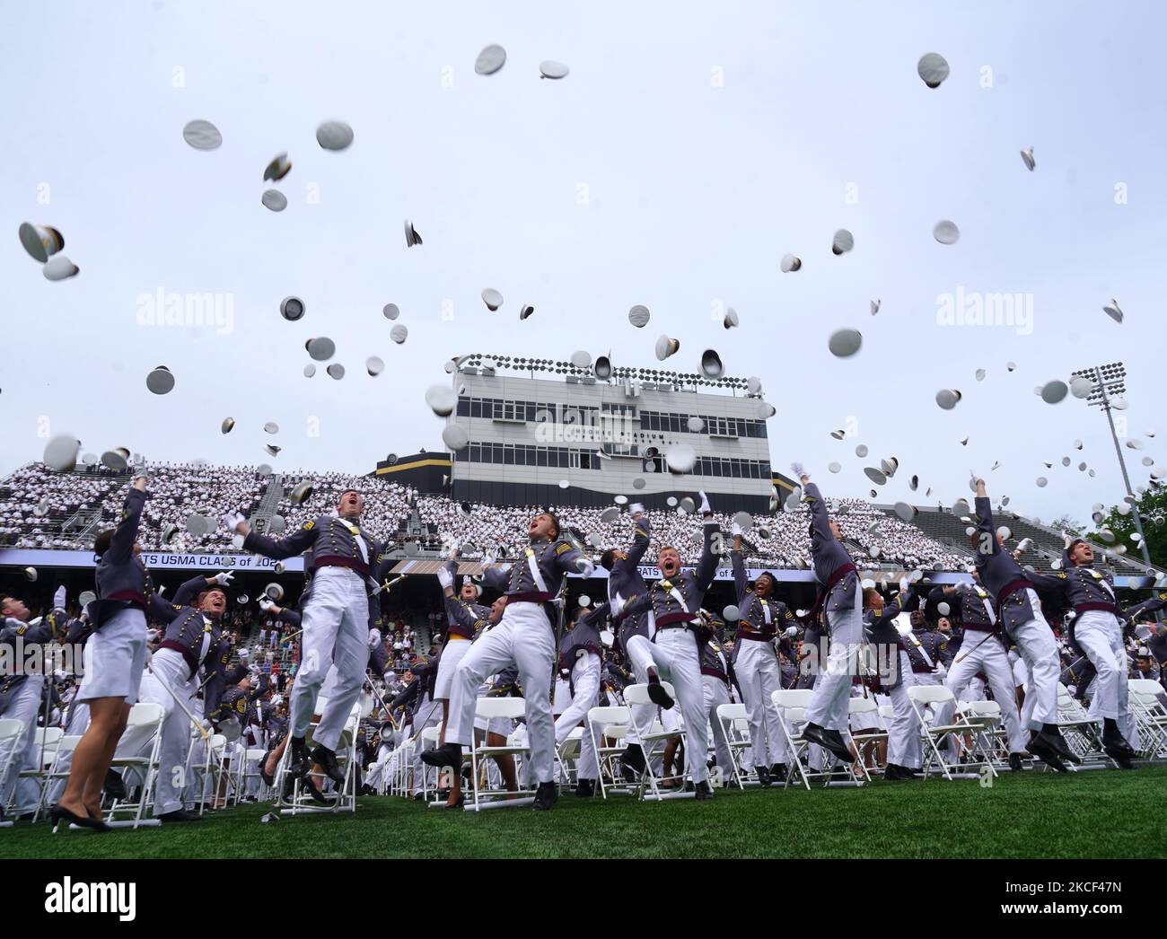 West Point graduates toss their hats in the air after the conclusion of