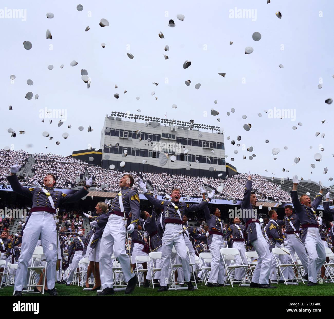 West Point graduates toss their hats in the air after the conclusion of
