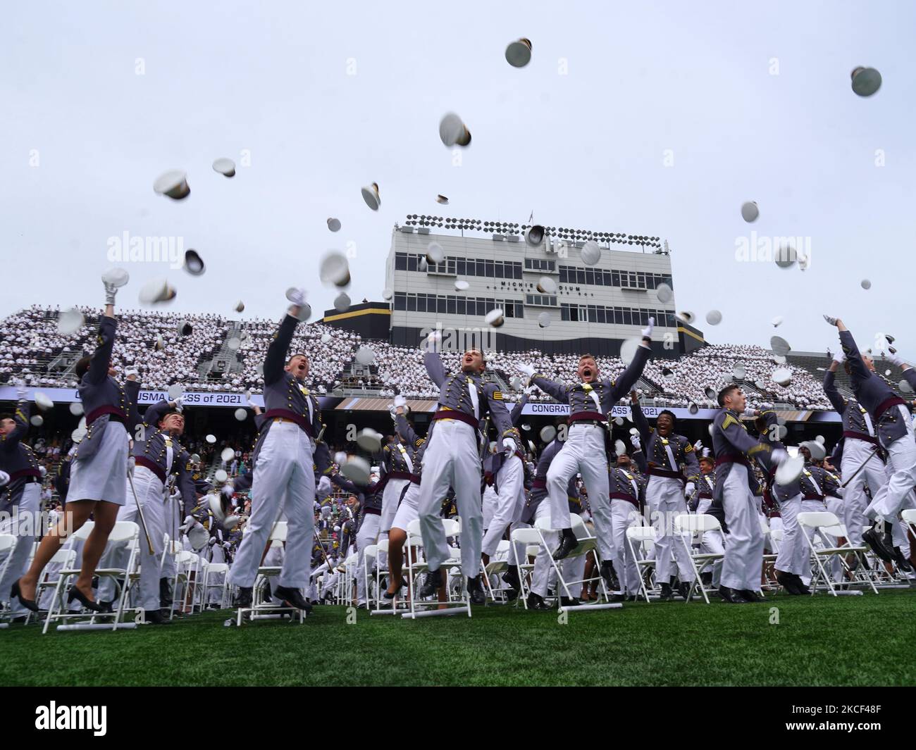 West Point graduates toss their hats in the air after the conclusion of