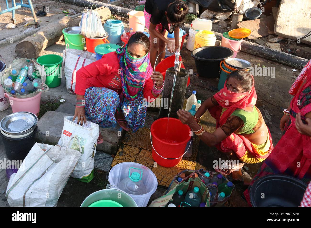 Women filling water pots and cans due to the shortage of water supply at a slum in Kolkata, India on May 23, 2021. (Photo by Debajyoti Chakraborty/NurPhoto) Stock Photo