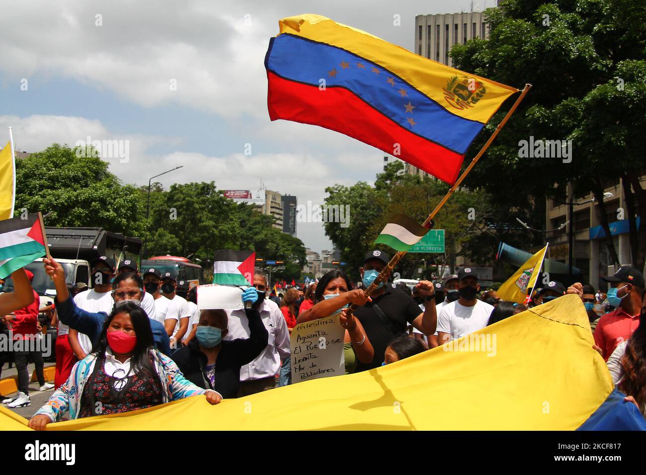A woman waves a Venezuelan flag during a march in solidarity with the Palestinian people over the armed conflict with the state of Israel, amid the Covid-19 pandemic, in Caracas, Venezuela on May 25, 2021. (Photo by Javier Campos/NurPhoto) Stock Photo