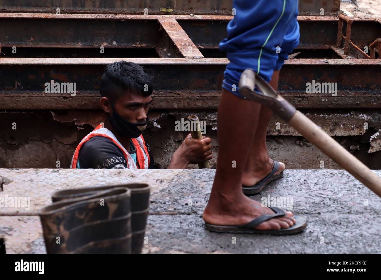 Municipality workers cleaning drains of Guwahati city ahead of flood