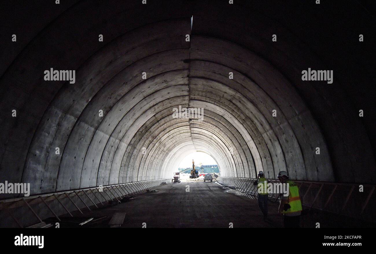 Workers walk through a tunnel under construction for the 2.7 billion, 170mile Brightline high