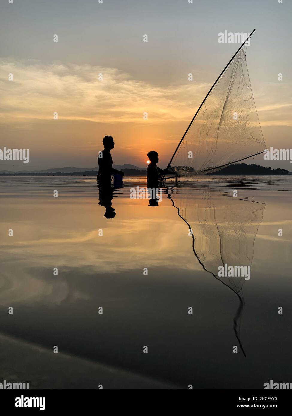 Men fishing in the Brahmaputra river at sunset, in Guwahati, Assam, India on 28 May 2021. (Photo