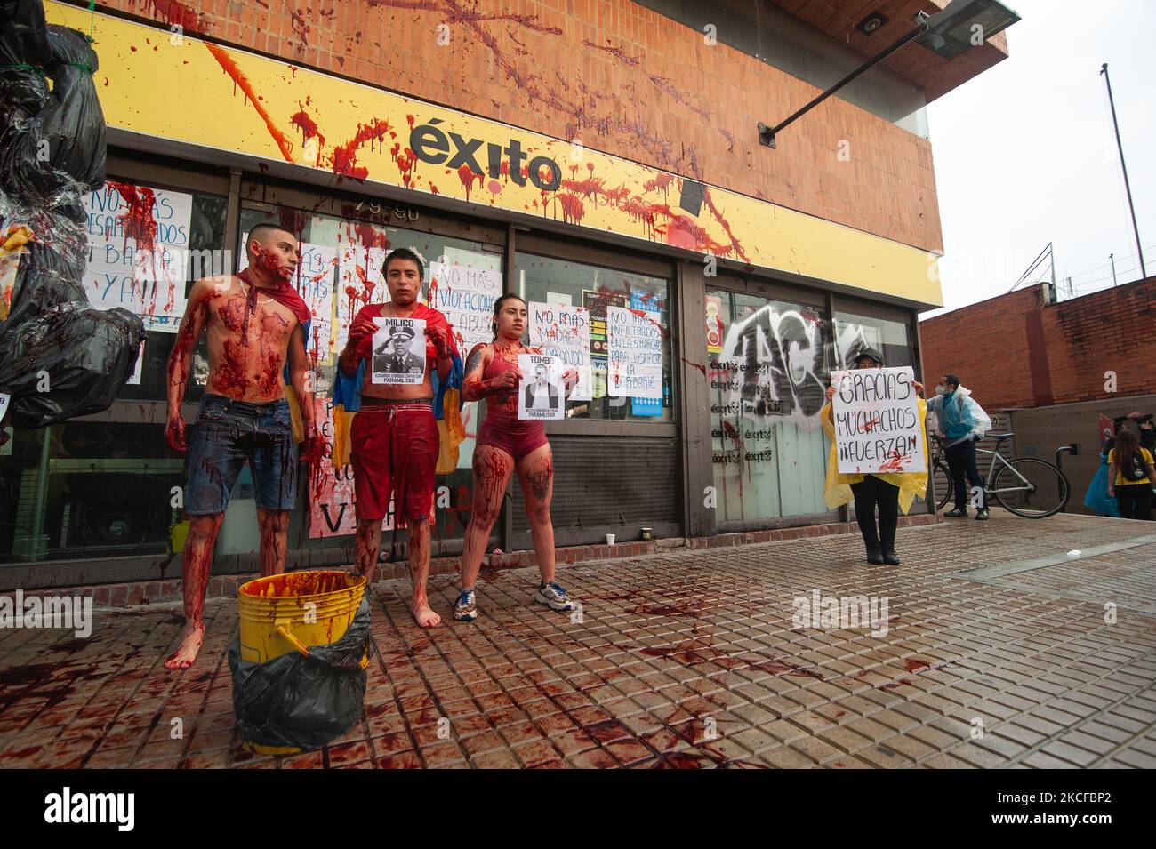 A group of demonstrators covered in fake blood make a performance against  torture as videos depicting torture and police brutality became viral after  demonstrators were captured inside a Exito Supermarket as thousands