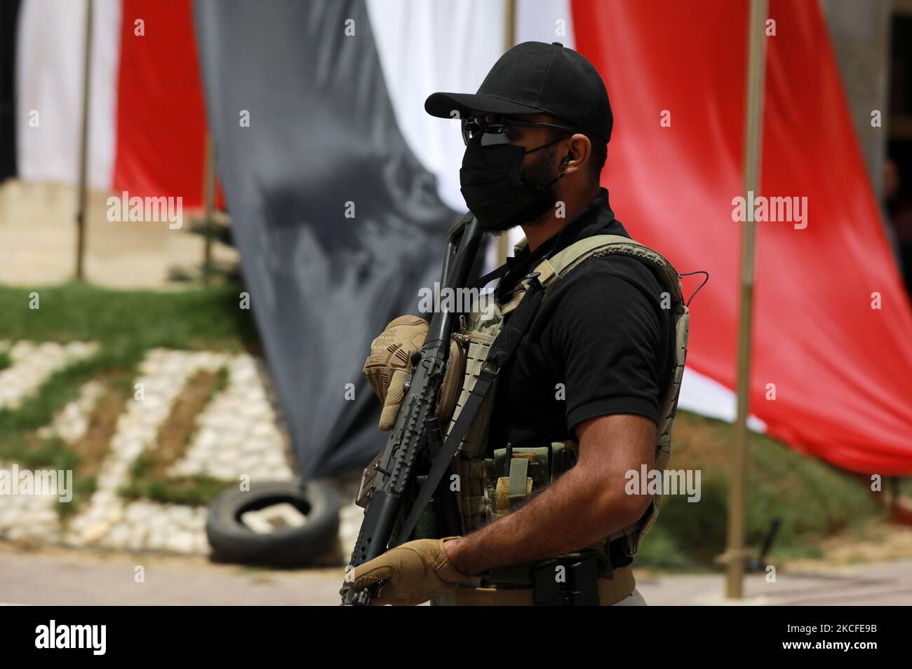 An Egyptian intelligence security detail member stands guard near a