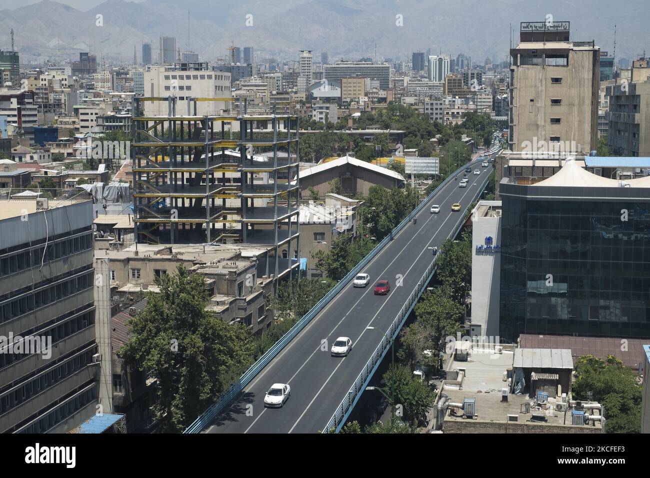 Tehran Driving Vehicles drive along a bridge in downtown Tehran on May 28, 2021 ...