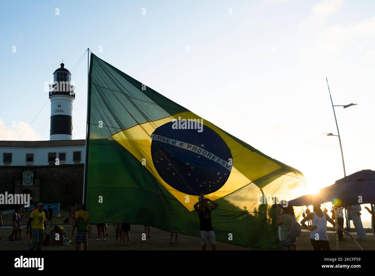Salvador, Bahia, Brazil - October 22, 2022: Supporters of the President of Brazil Jair Bolsonaro, place a large Brazilian flag at Farol da Barra squar Stock Photo