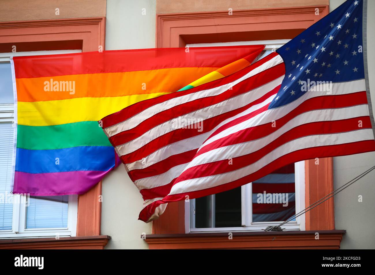 LGBT pride flag is hanging next to the US national flag over the ...