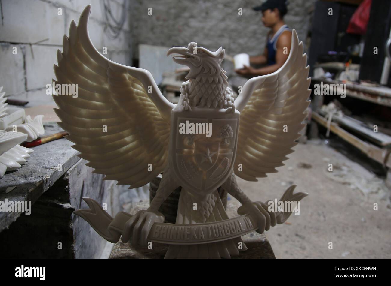 Craftsmen make a statue of Garuda Pancasila as the symbol of the state in a home industry in the Greater Bali area, Kalimalang, East Jakarta, On JUNE, 2, 2021. This business has revived during the Covid-19 pandemic as orders from various national symbols arrived from a number of regions from inside and outside Indonesia to be used as office and school wall decorations. (Photo by Dasril Roszandi/NurPhoto) Stock Photo