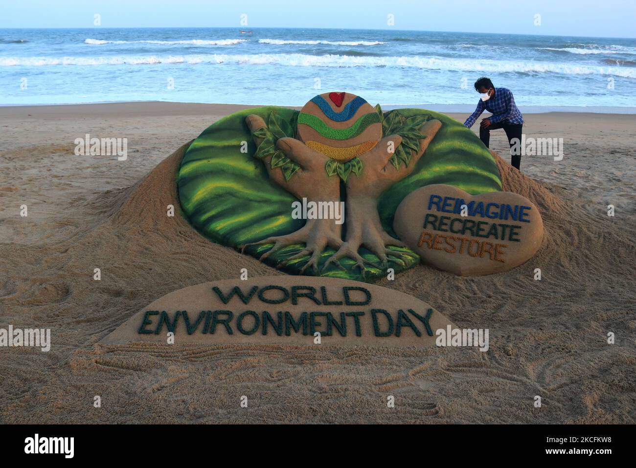 Environment Day sand sculpture is seen at the Bay of Bengal Sea's Puri