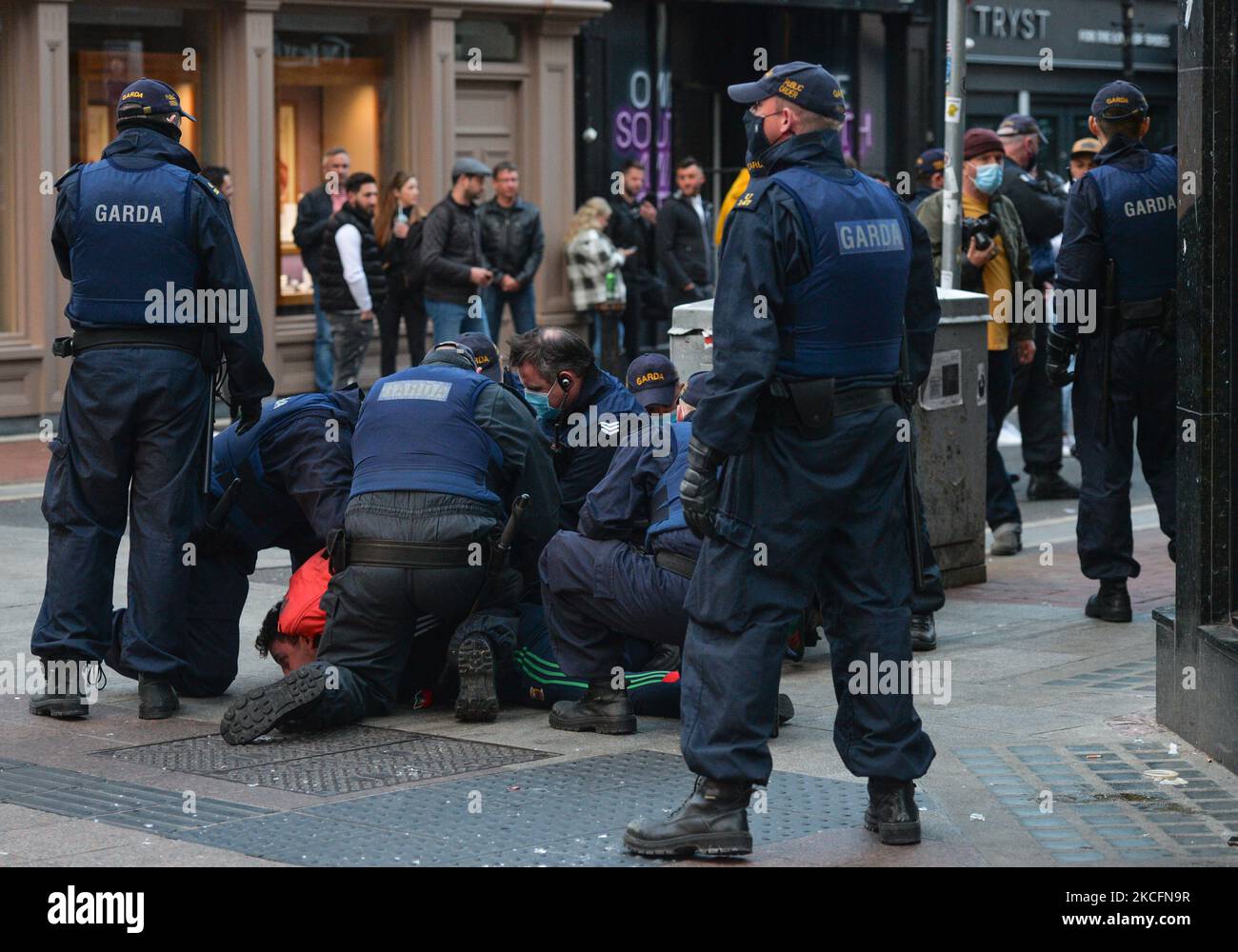 Members of Gardai surround a young man on Grafton Street in Dublin, on Saturday evening, June 5, 2021. Nineteen people were arrested on suspicion of violating public order after another night of rioting in downtown Dublin. Glass bottles and other missiles were thrown at the gardai after they collided with large crowds in the city on Saturday night. On Sunday, 6 June 2021, in Dublin, Ireland. (Photo by Artur Widak/NurPhoto) Stock Photo