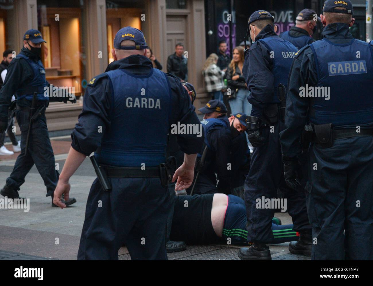 Members of Gardai surround a young man on Grafton Street in Dublin, on Saturday evening, June 5, 2021. Nineteen people were arrested on suspicion of violating public order after another night of rioting in downtown Dublin. Glass bottles and other missiles were thrown at the gardai after they collided with large crowds in the city on Saturday night. On Sunday, 6 June 2021, in Dublin, Ireland. (Photo by Artur Widak/NurPhoto) Stock Photo