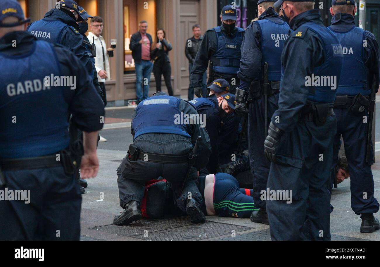 Members of Gardai surround a young man on Grafton Street in Dublin, on Saturday evening, June 5, 2021. Nineteen people were arrested on suspicion of violating public order after another night of rioting in downtown Dublin. Glass bottles and other missiles were thrown at the gardai after they collided with large crowds in the city on Saturday night. On Sunday, 6 June 2021, in Dublin, Ireland. (Photo by Artur Widak/NurPhoto) Stock Photo