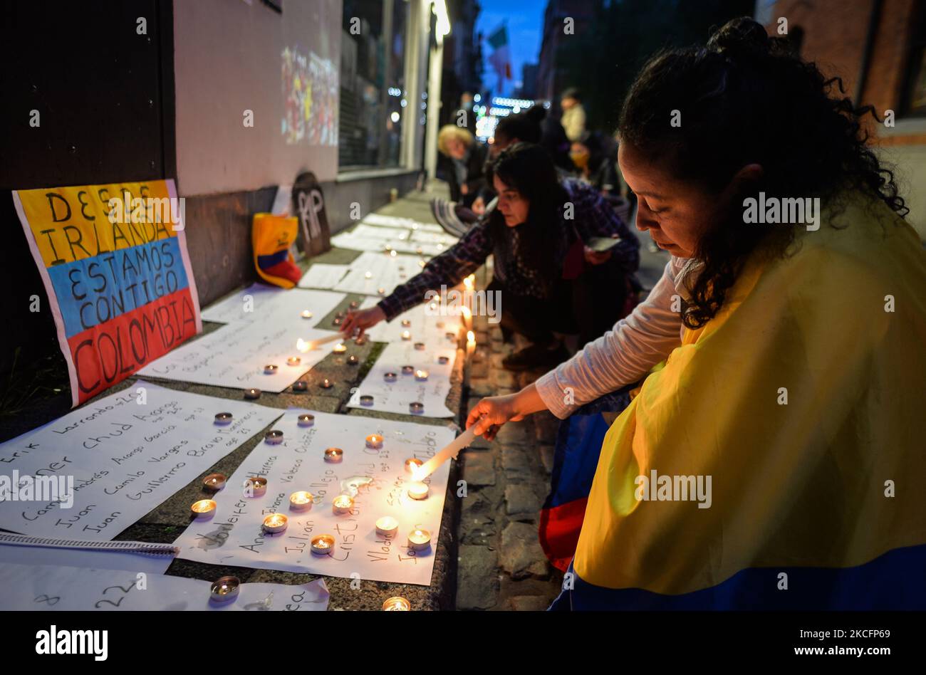 Members of the Colombian Diaspora in Dublin light candles during the