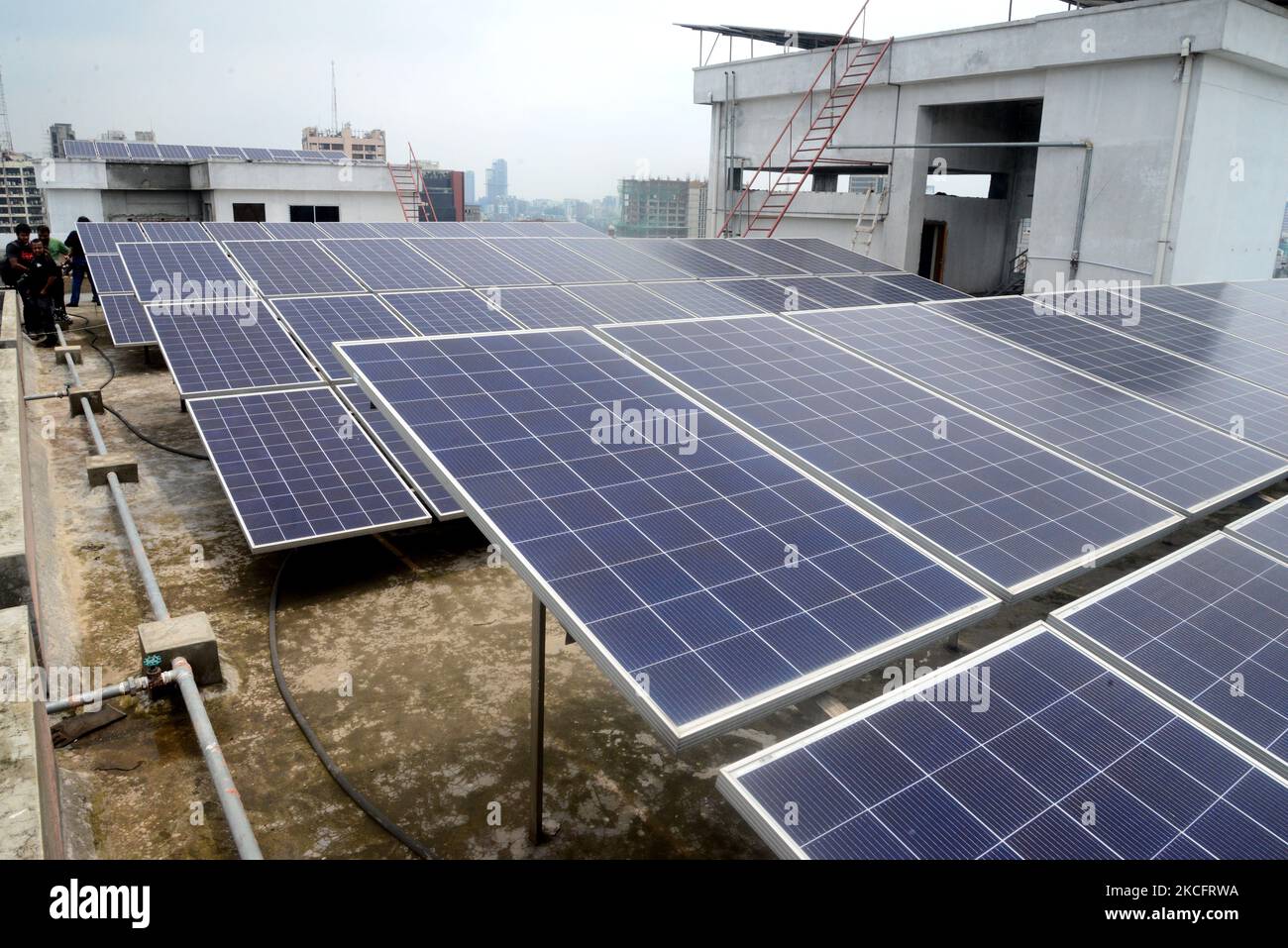 Solar energy panels are seen on the rooftops of a high rise building in
