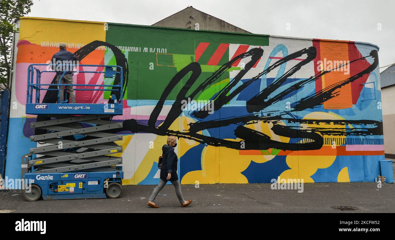 Irish artist Maser, finishing his new mural located at the corner of