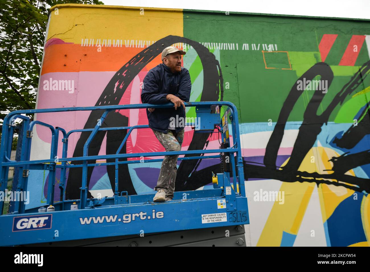 Irish artist Maser, in front of his new mural located at the corner of