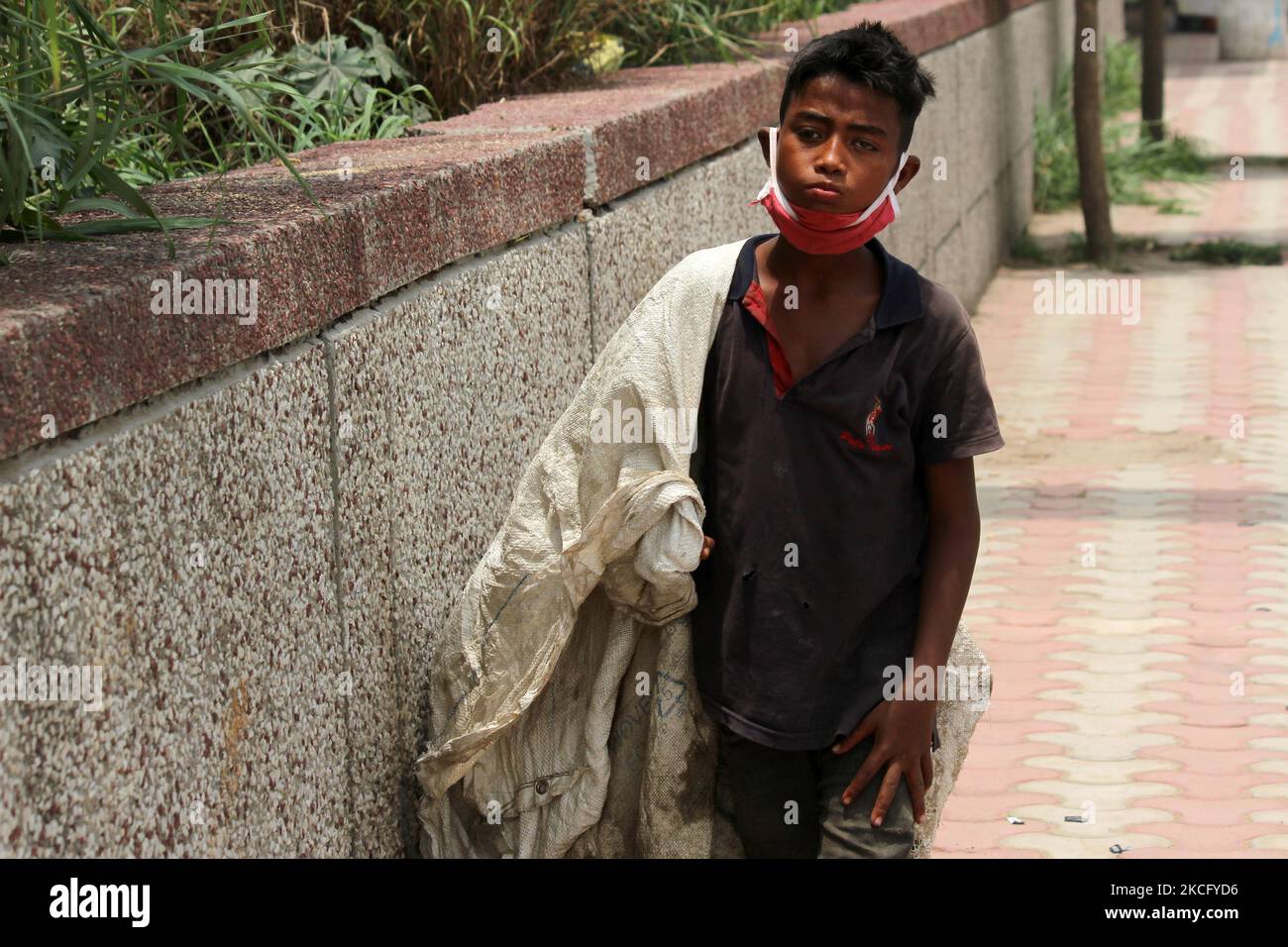 Rahul, 8, a ragpicker looks for recyclable materials specially plastic ...