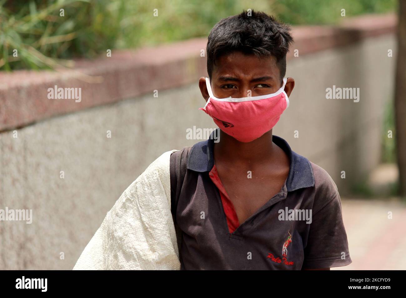 Rahul, 8, a ragpicker looks for recyclable materials specially plastic ...