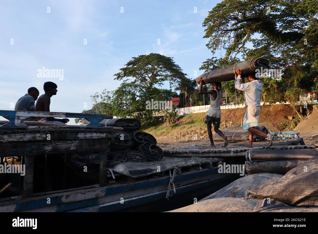 Labourers working in the banks of Brahmaputra river to prevent soil erosion, in Guwahati, Assam