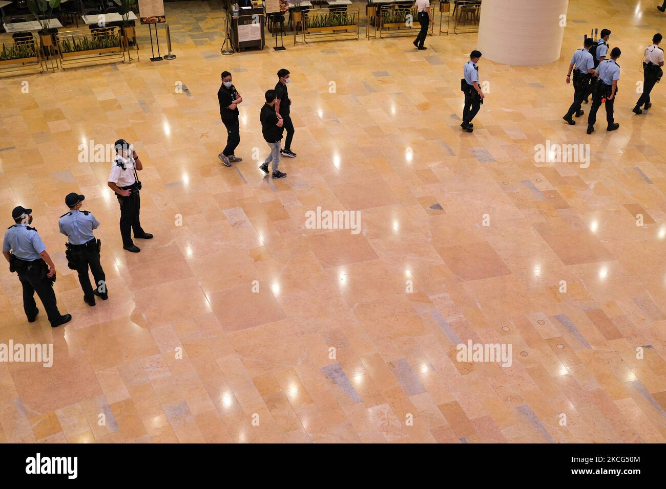 Police entered the mall to patrol, in Hong Kong, China, on June 15, 2021. June 15, 2021, is the second anniversary of the death of Hong Kong's first Anti-ELAB Movement protester. Many citizens came to mourn and offer flowers spontaneously. Police officers were also present at the scene to control the flow of people on the grounds of epidemic prevention. (Photo by Leung Man Hei/NurPhoto) Stock Photo