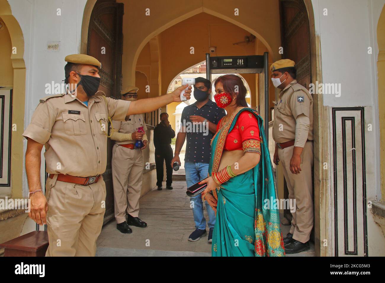 Jaipur: Tourists undergo thermal screening before visit at Hawa Mahal , that reopened after authorities eased some restrictions in the ongoing Covid-19 lockdown, in Jaipur, Rajasthan, India, on June 16, 2021.(Photo by Vishal Bhatnagar/NurPhoto) Stock Photo