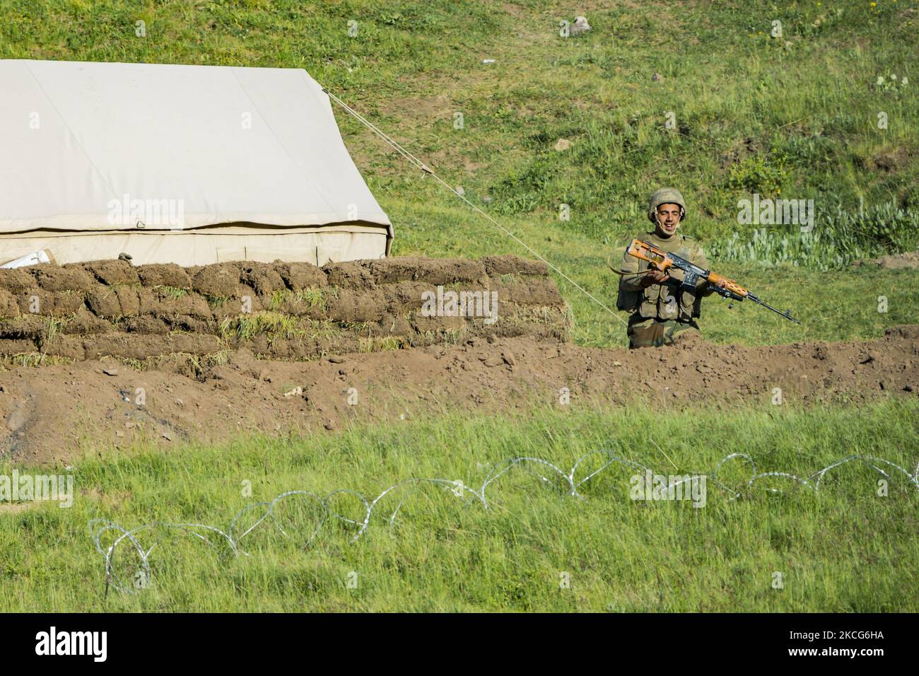 Azeri soldier prepares and charges his sniper rifle in an advanced detachment inside the armenian territory in the Gegharkunik province, Armenia. Azerbaijan army is interned some kilometers from the oficial border between Armenia and Azerbaijan. Distances between soldiers are only 50 meters in some cases. (Photo by Celestino Arce/NurPhoto) Stock Photo
