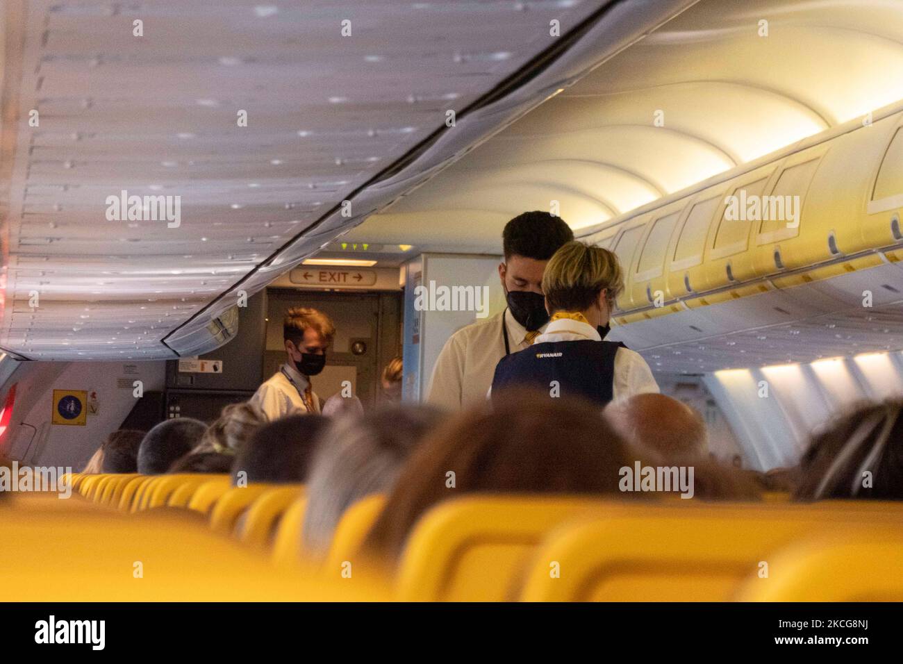 Flight Attentands wearing facemasks during the flight. Flying during