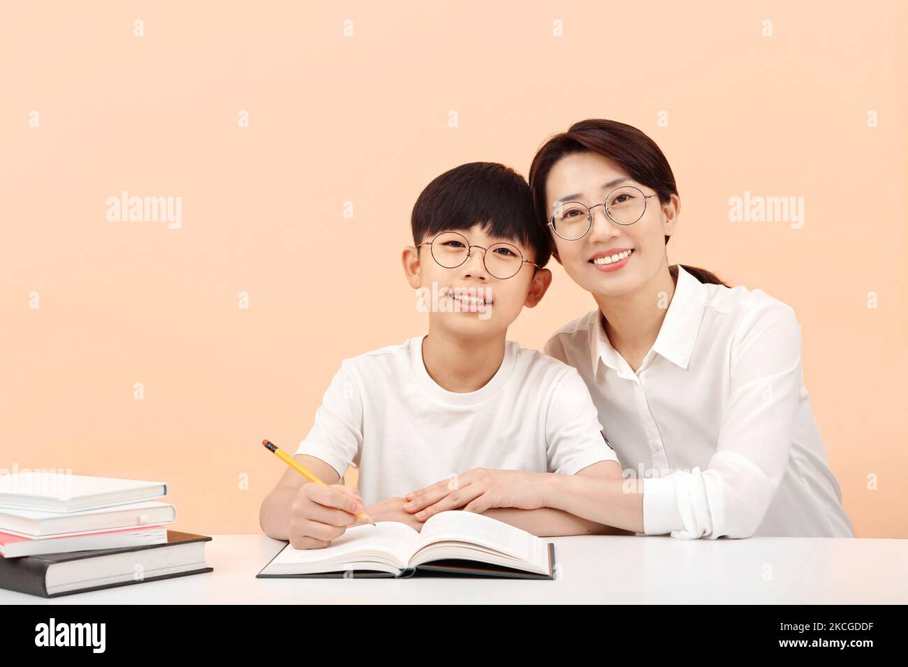Happy learning time A student studying happily with a teacher or mother with a bright smile Stock Photo