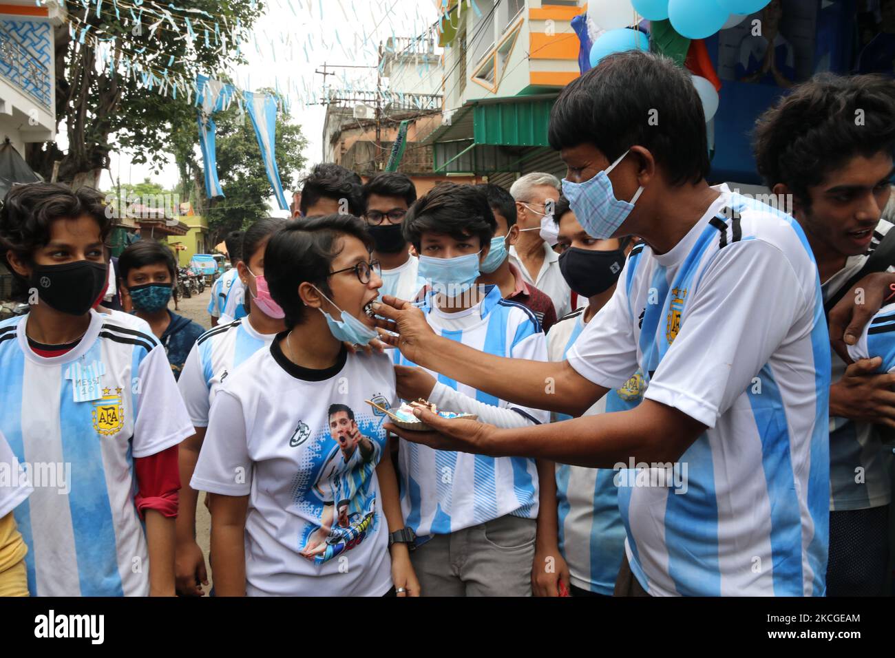 Shib Shankar Patra ( R ), football fan of Argentina team, with Argentina fans Club members during 34th birthday celebration of the world famous professional footballer Lionel Messi at North 24 Pargana Kolkata to 27 Kilometer distances north, West Bengal, India, on June 24, 2021. (Photo by Debajyoti Chakraborty/NurPhoto) Stock Photo