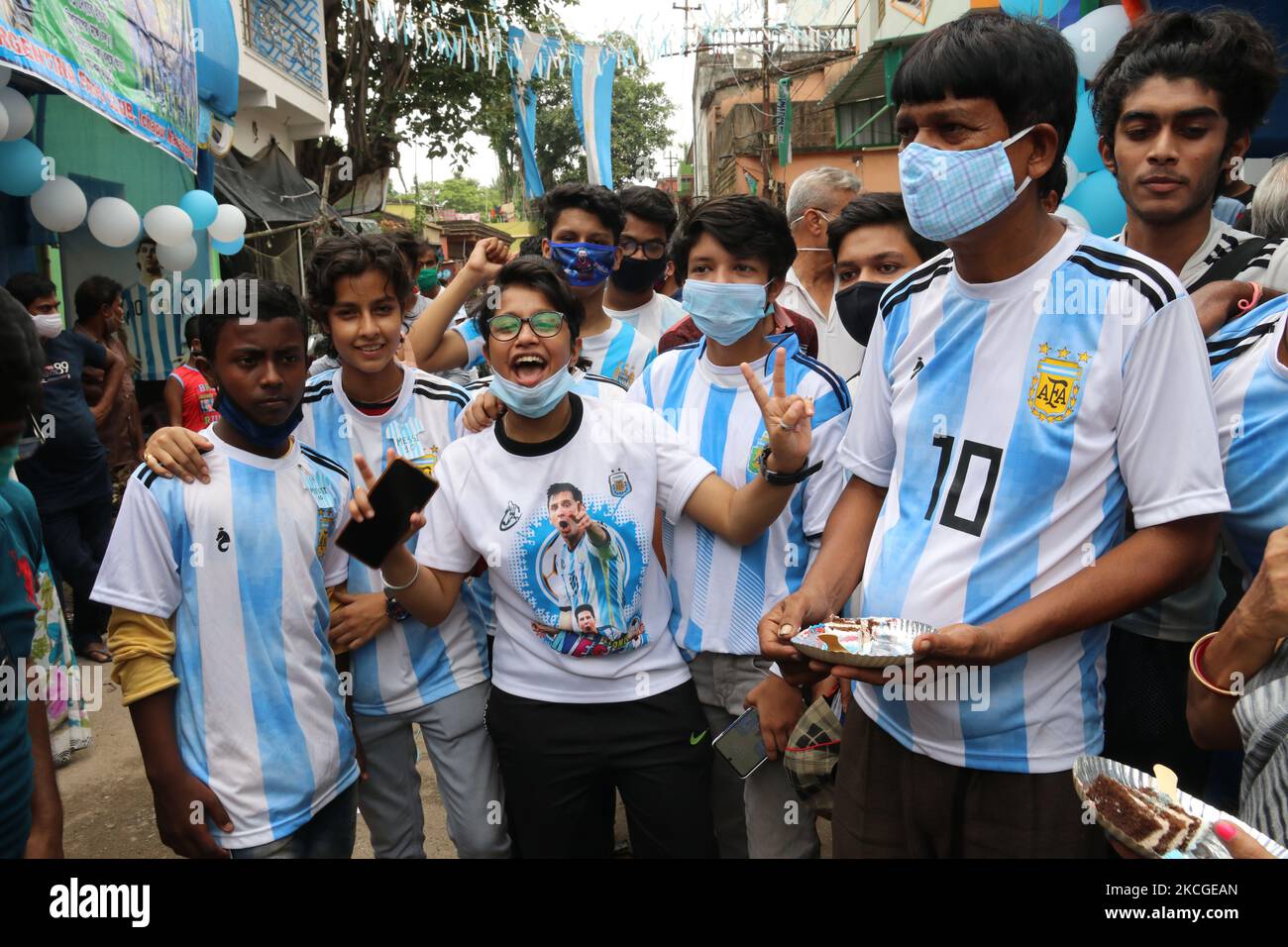 Shib Shankar Patra ( R ) , football fan of Argentina team, with Argentina fans Club members during 34th birthday celebration of the world famous professional footballer Lionel Messi at North 24 Pargana Kolkata to 27 Kilometer distances north, West Bengal, India, on June 24, 2021. (Photo by Debajyoti Chakraborty/NurPhoto) Stock Photo