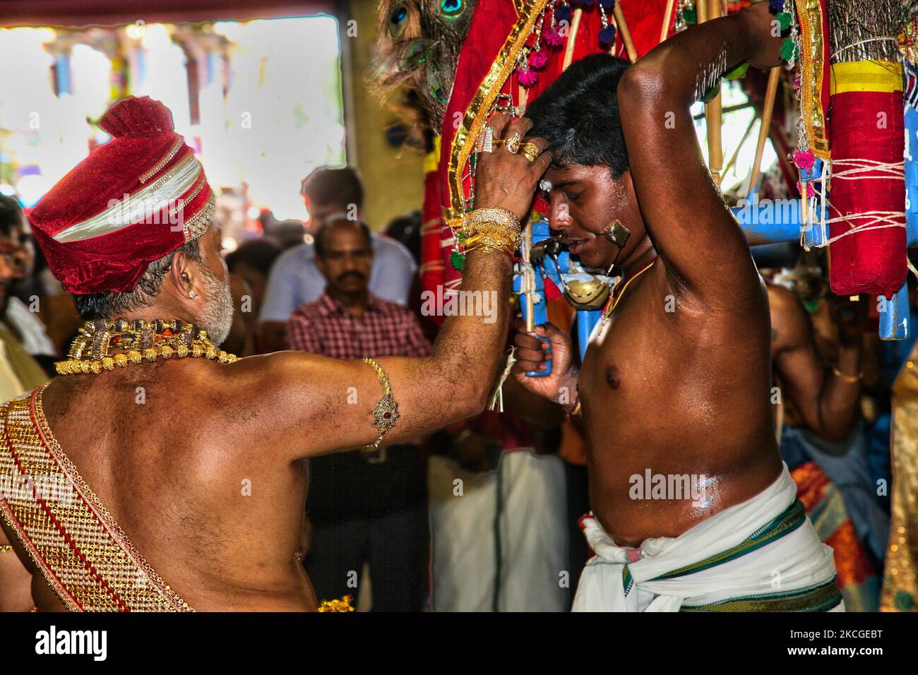 Tamil Hindu devotee receives blessings from a Hindu priest after ...