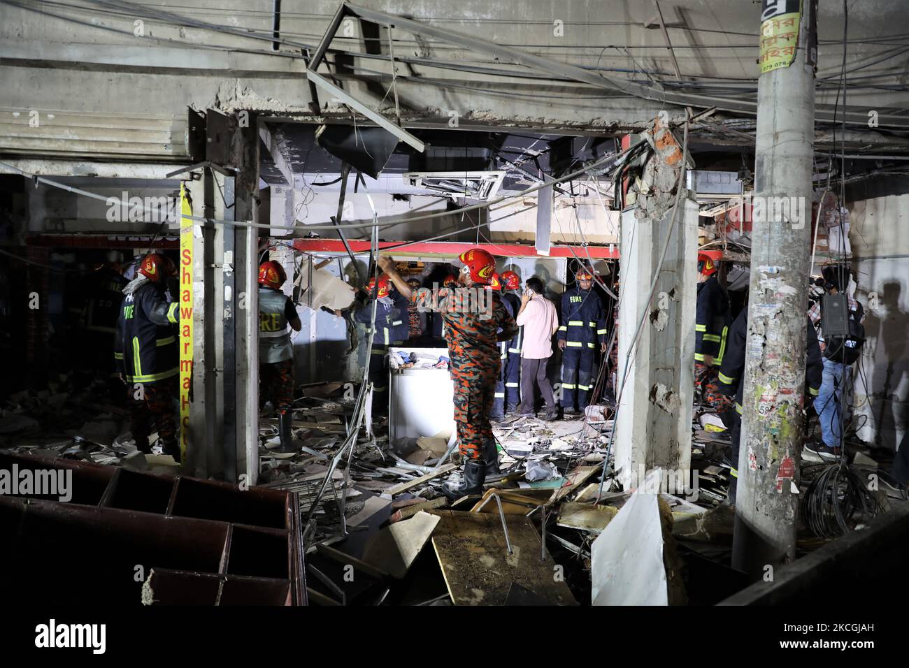 Fire rescue workers inspect the site after a massive blast occurred in a shop that killed several people in Dhaka, Bangladesh on June 27, 2021. (Photo by Syed Mahamudur Rahman/NurPhoto) Stock Photo