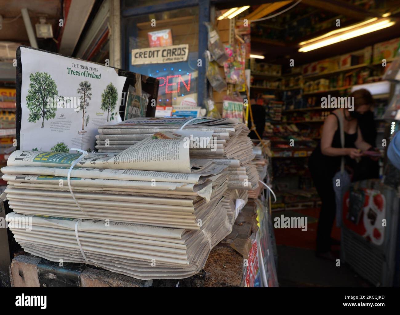 Newspapers piled up seen near the entrance to Dun Leary's Last Corner Shop. On Sunday, 27 June 2021, in Dun Laoghaire, County Dublin, Ireland. (Photo by Artur Widak/NurPhoto) Stock Photo