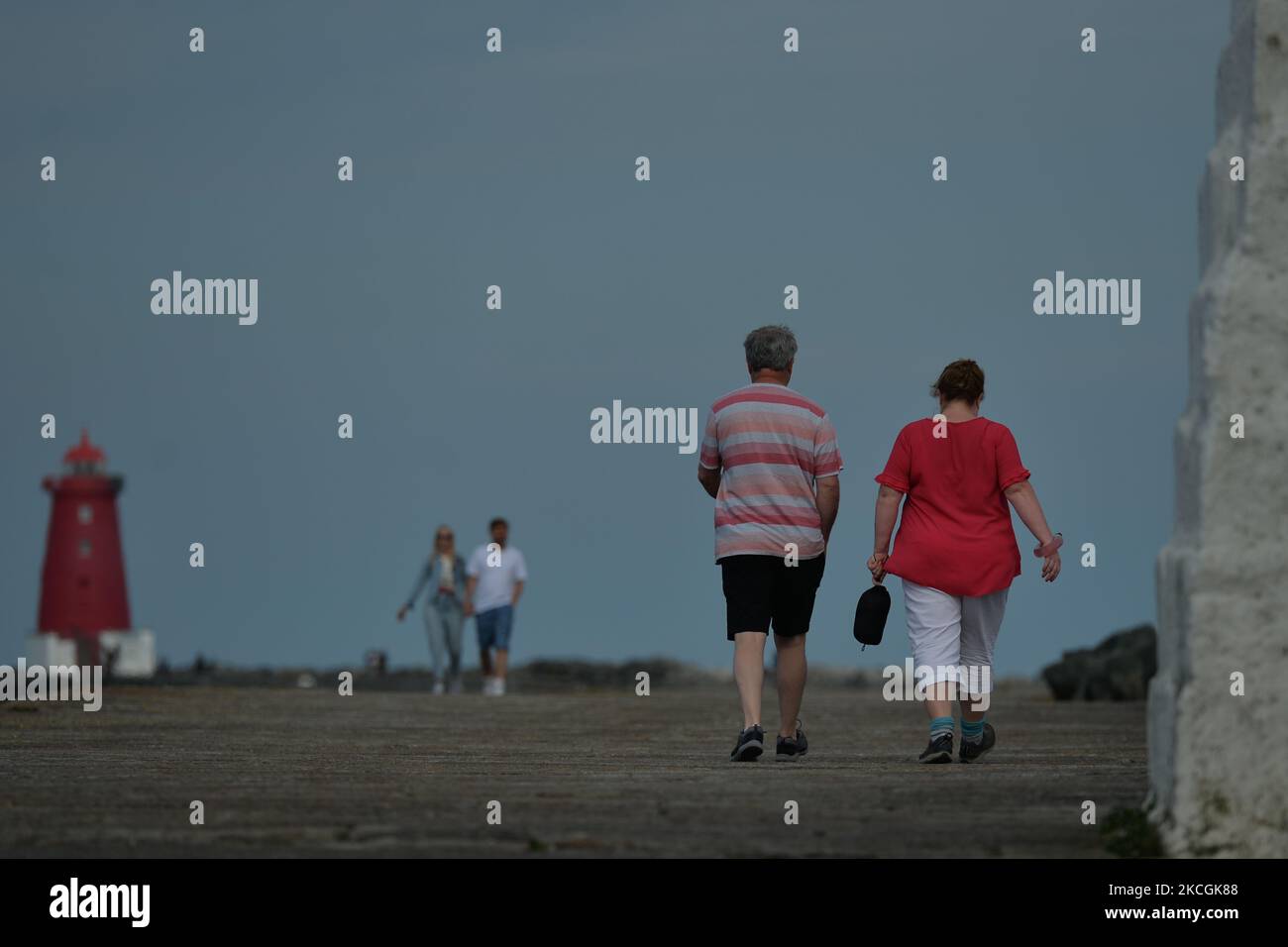 People walking on the Great South Wall in Poolberg, Dublin. On Monday