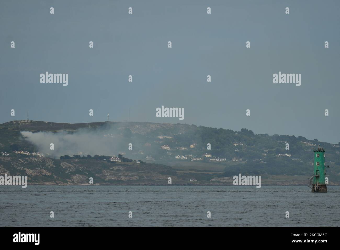 Gorse fires in Howth seen from the Great South Wall in Poolberg. For the past few days gorse fires raged just metres away from people out enjoying a game of golf in Howth. On Tuesday, 29 June 2021, in Dublin, Ireland. (Photo by Artur Widak/NurPhoto) Stock Photo
