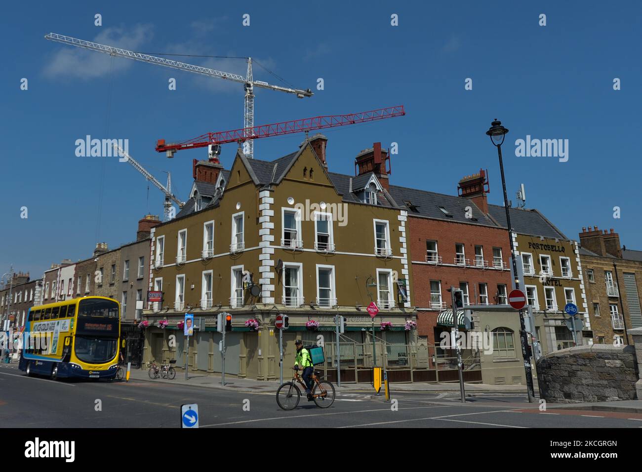Construction cranes over a construction site located behind The