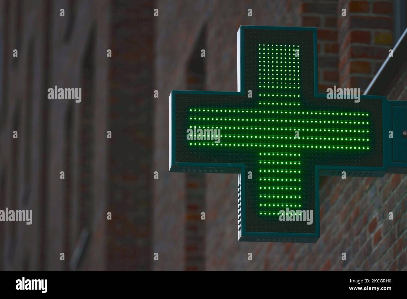 Neon pharmacy cross sign seen in Dublin city center. From Monday