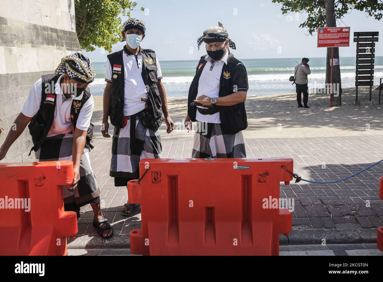Balinese local guards closes the beach main entrance during emergency