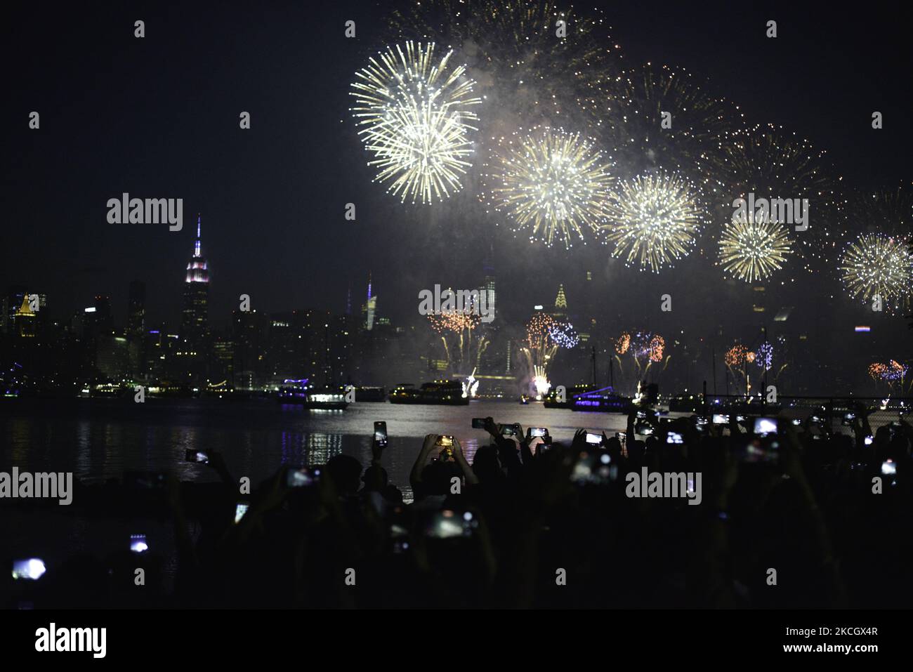 The Manhattan skyline (as seen from the East River) is lit up with