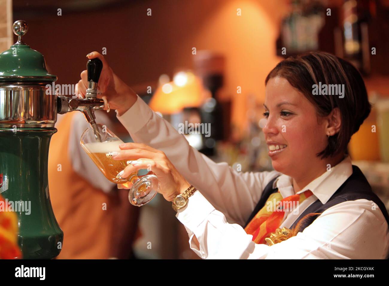 Bartender pours Cristal Beer (a typical Cuban beer) at a bar in ...