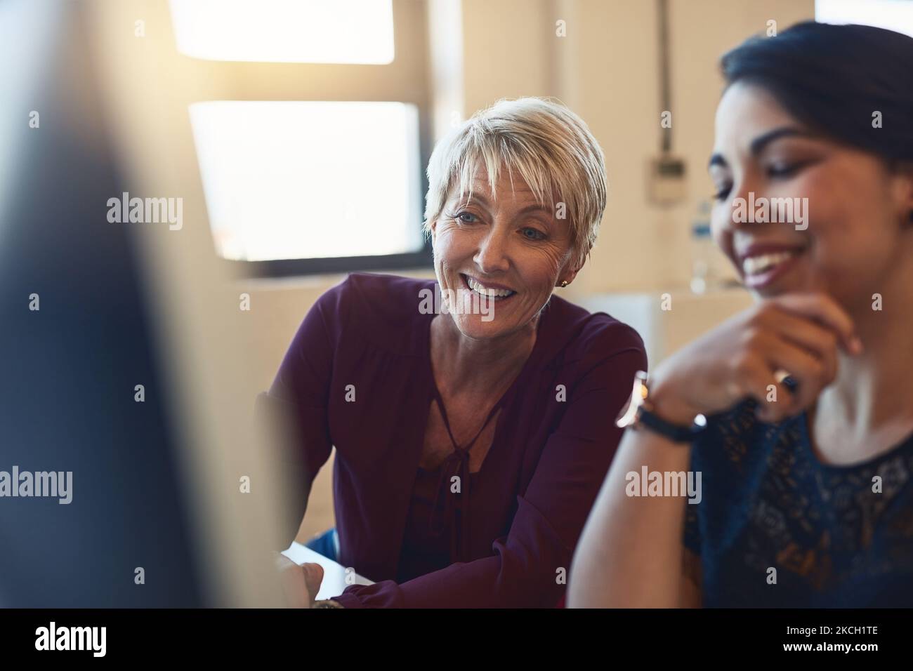 This right here is our winning idea. two designers working together on a computer in an office. Stock Photo