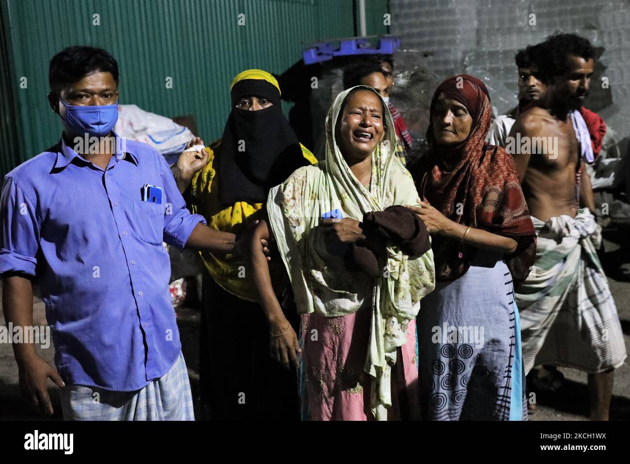 Nazma Akhter mourns for her missing son near a fire scene of a juice